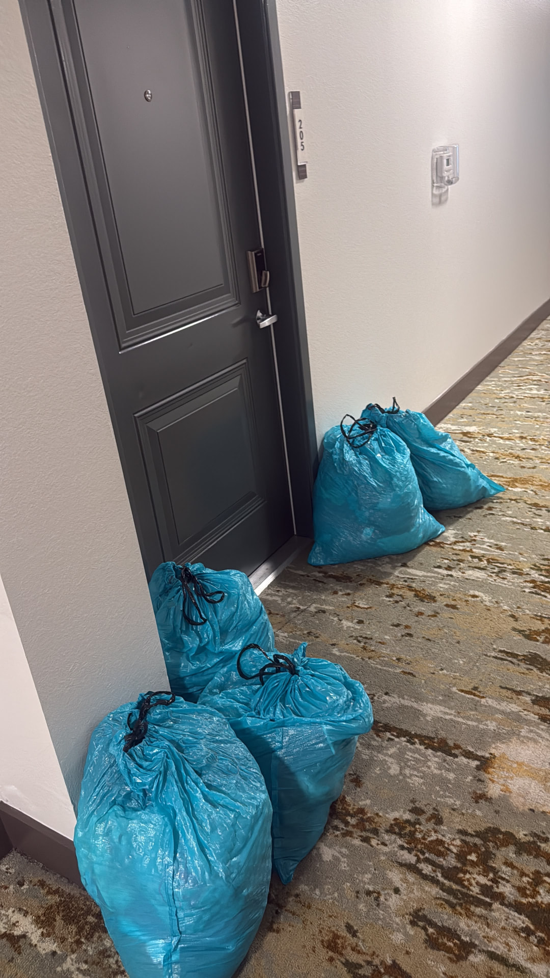 Neatly tied donation bags waiting by a front door